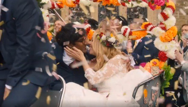 Biodegradable confetti falling over bride and groom